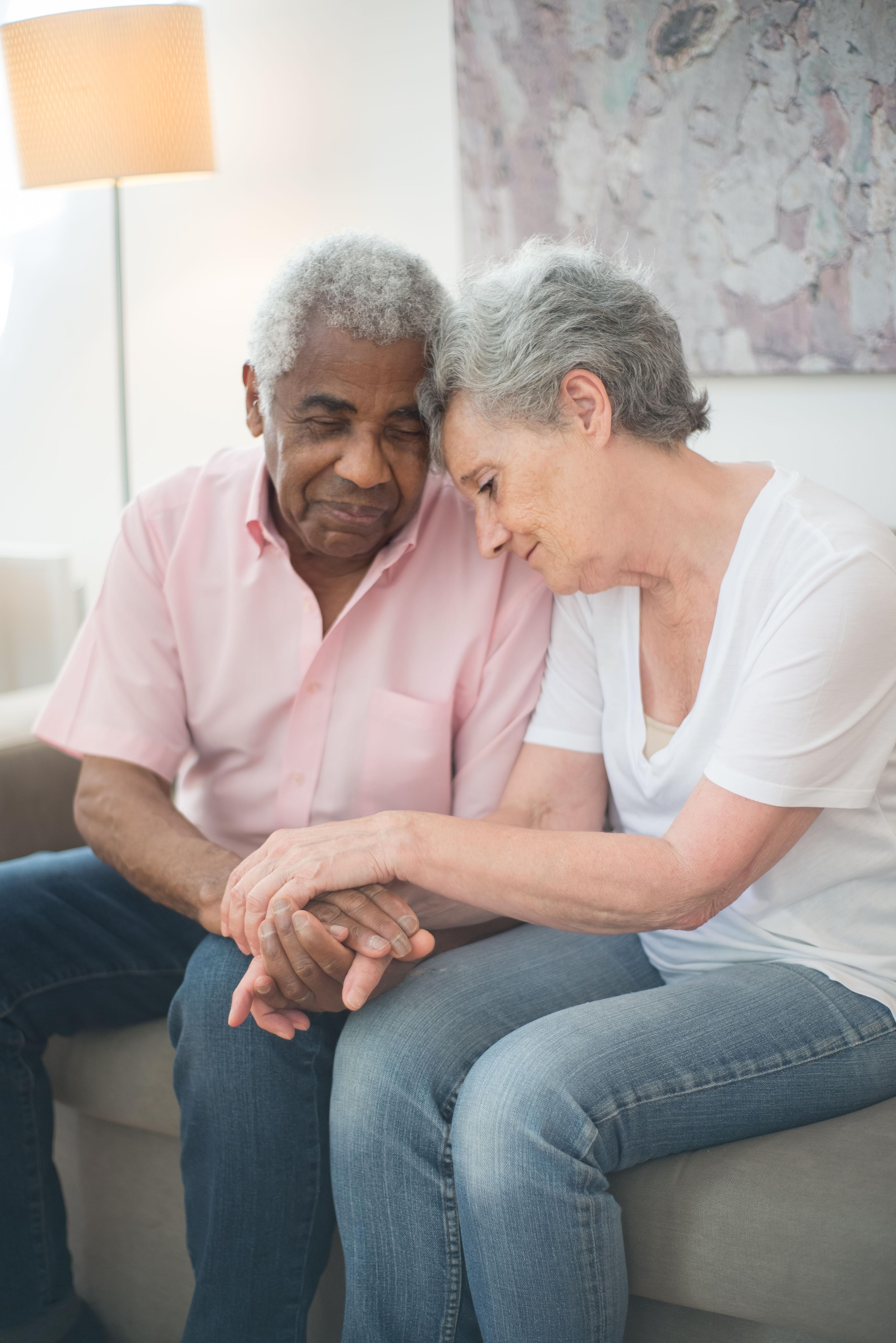 A caregiver sharing a calm moment with an older couple at home